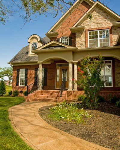 A single family home in Nashville, Tennessee on a bright summer day with a clear blue sky.